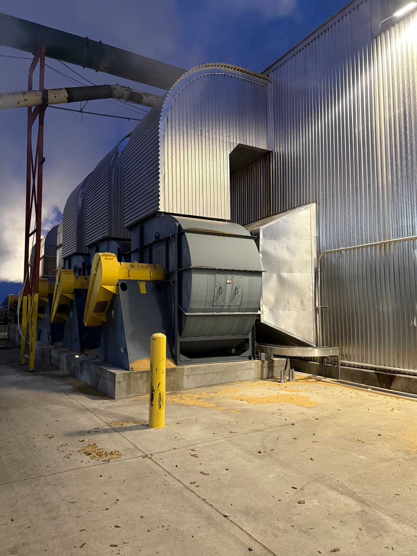 Kiln fan blowers and heat system running at dusk at a lumber facility