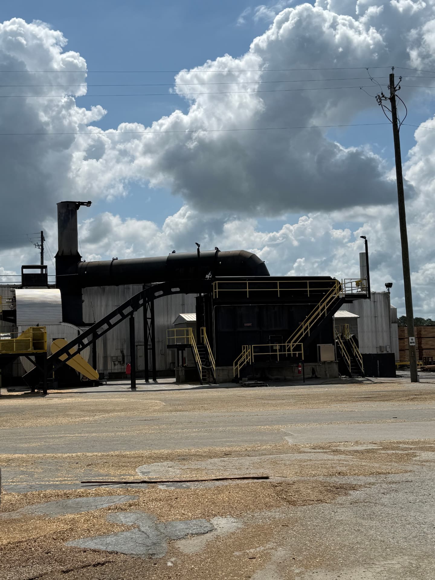Biomass energy system with boiler and ductwork supplying dry kilns