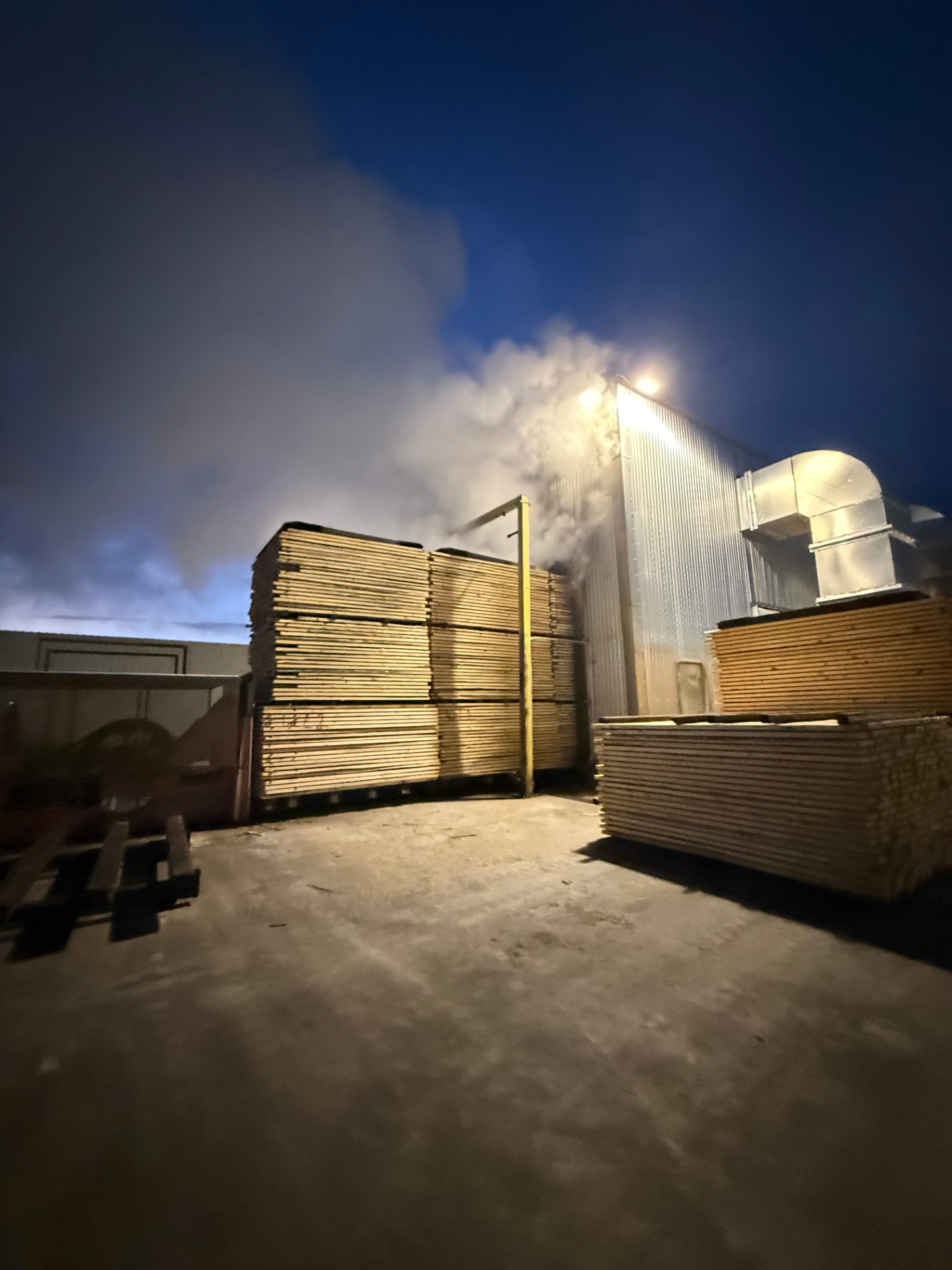 Industrial dry kiln venting steam during a night drying cycle