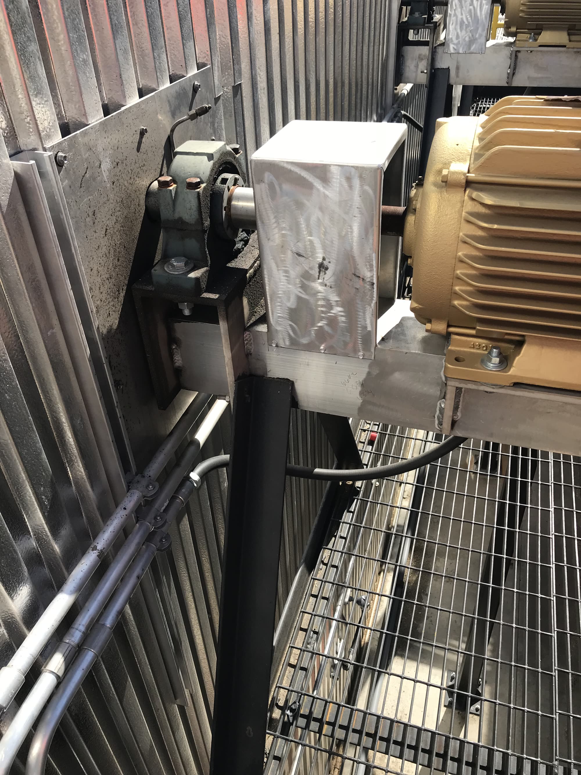 Kiln fan motor, pillow block bearing, and grease line on a fan deck