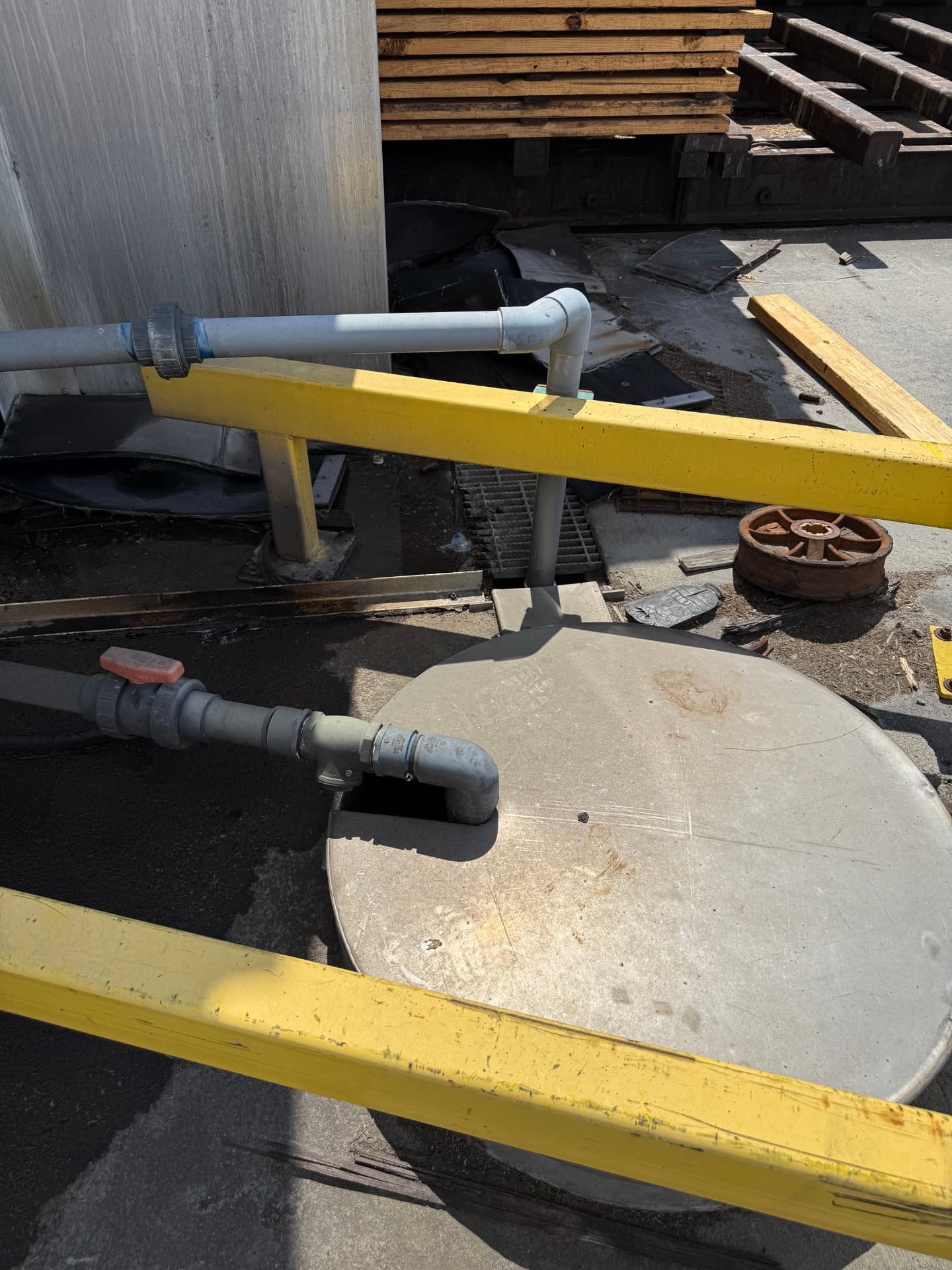 Kiln condensate piping, valve, and manhole cover on the kiln pad