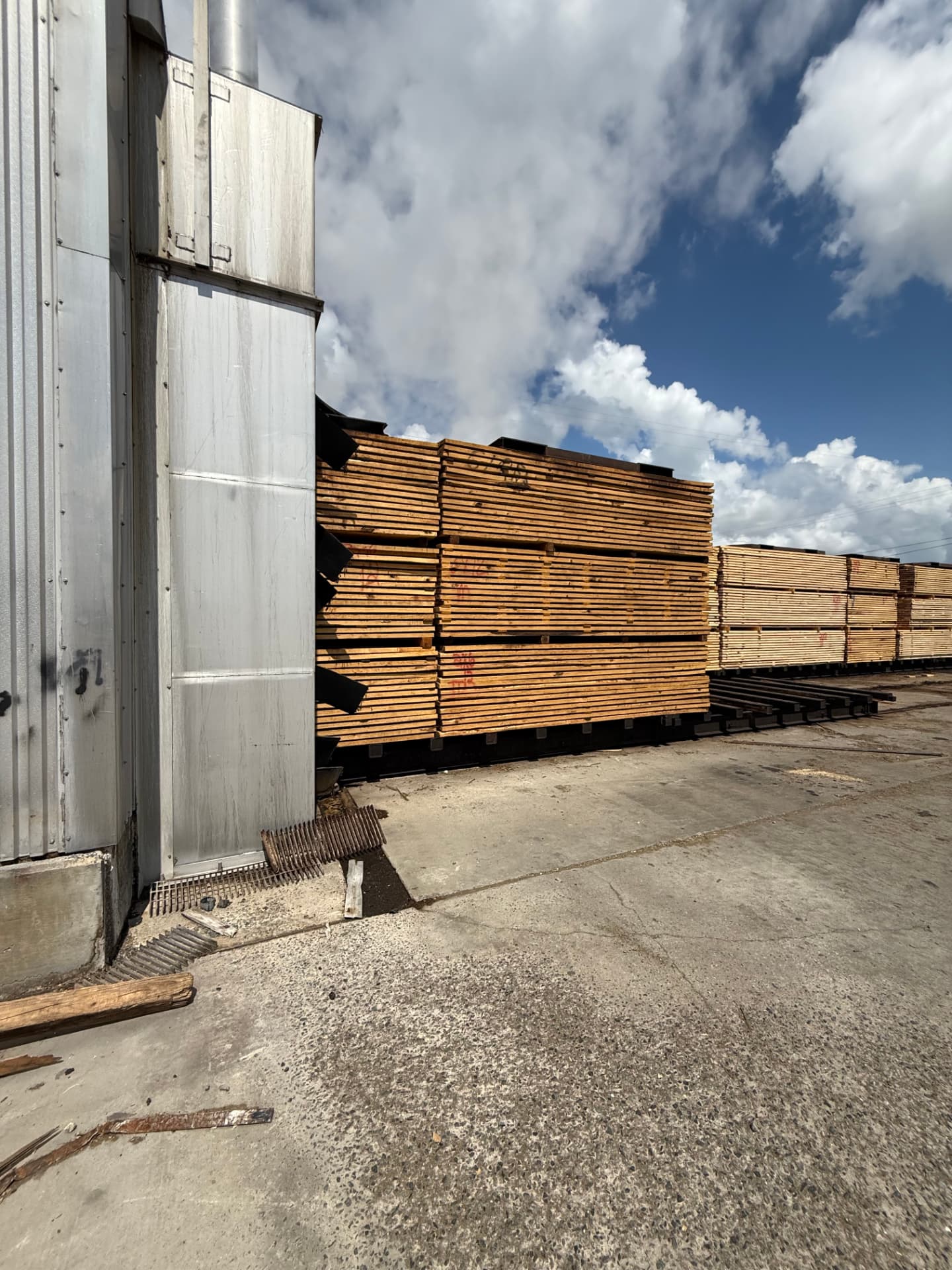 Lumber charge staged at an industrial dry kiln door at a sawmill