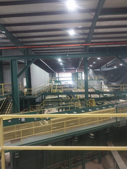 Multi-level industrial mezzanine and walkway system inside a lumber processing plant